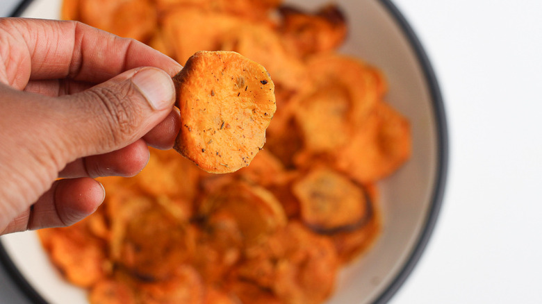 holding a sweet potato chip