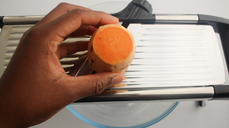 slicing sweet potato on mandoline