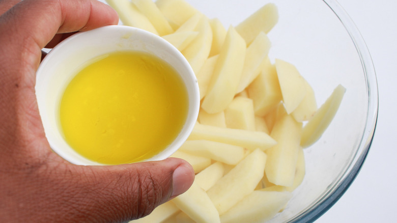 truffle oil poured onto potatoes