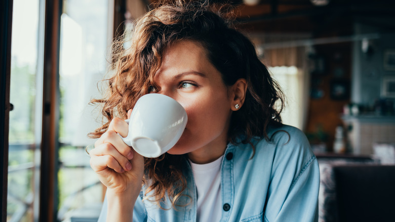 Woman drinking cup of coffee