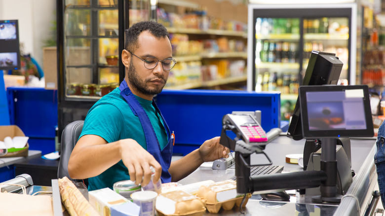 cashier sitting while working