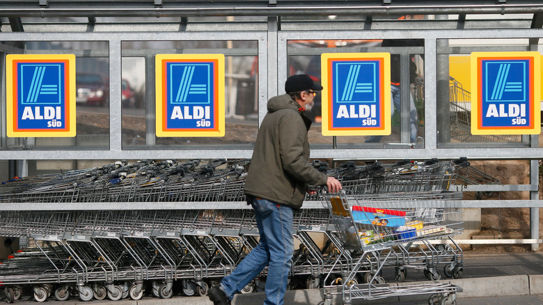 man walking with Aldi cart