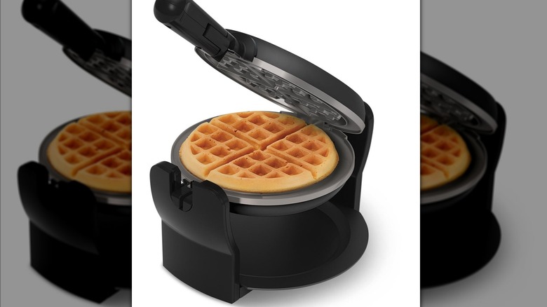 open waffle maker displaying waffle