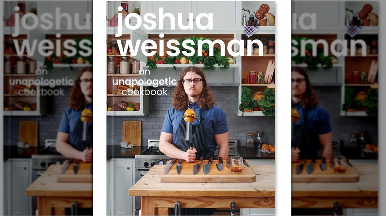 cookbook cover with man holding burger on knife