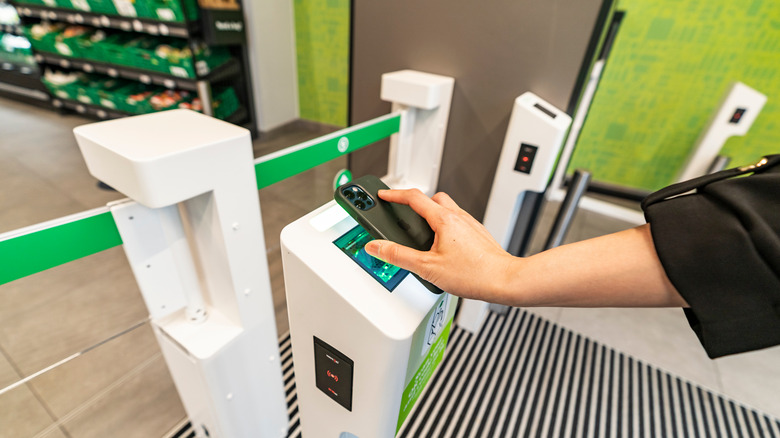 A customer using a cashierless checkout at an Amazon Go location