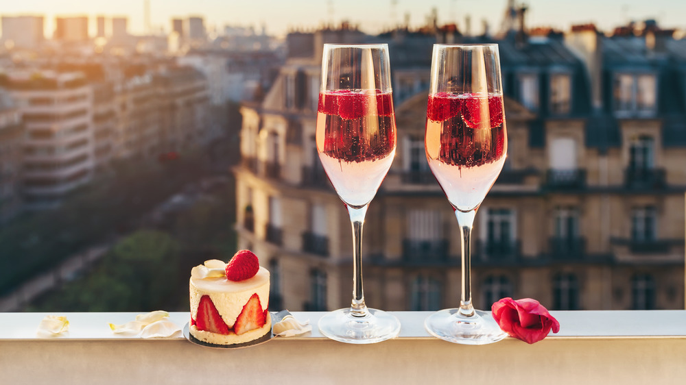 Two glasses on pink wine by window