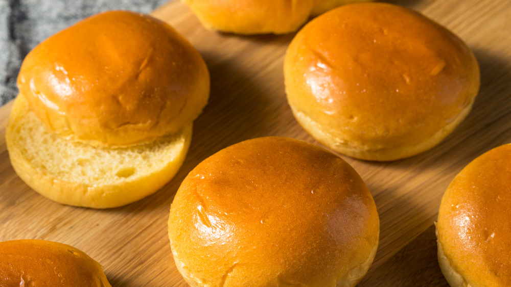 Hamburger buns on a wooden board