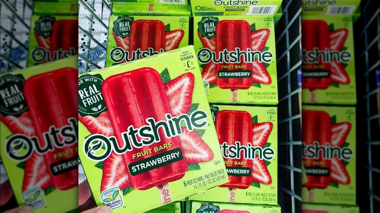 Boxes of Outshine strawberry fruit bars in a shopping cart