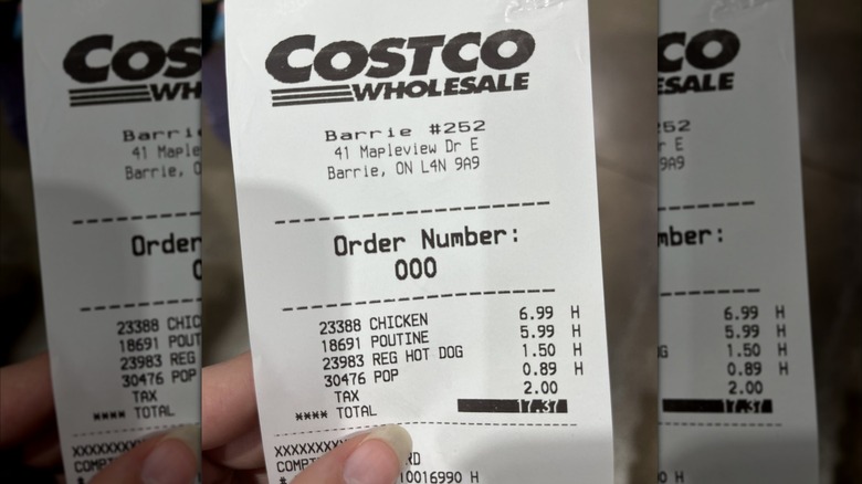 Hand holding a Costco receipt