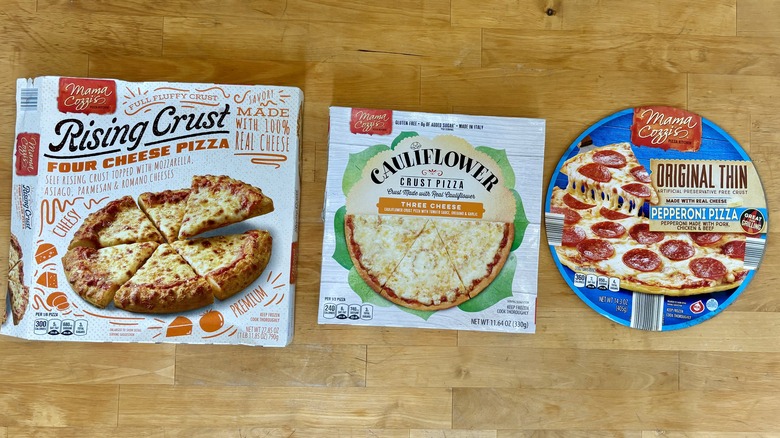 three frozen pizza boxes