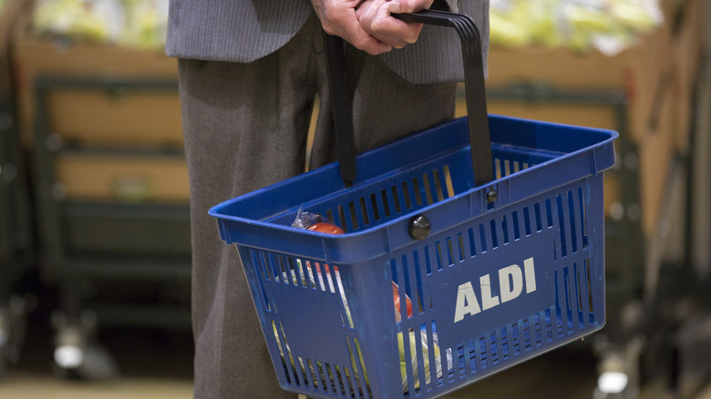 Person holding Aldi basket