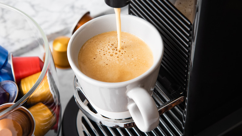 Coffee pod machine making coffee