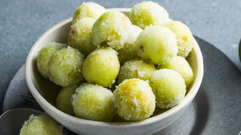 Frozen green grapes in a white bowl