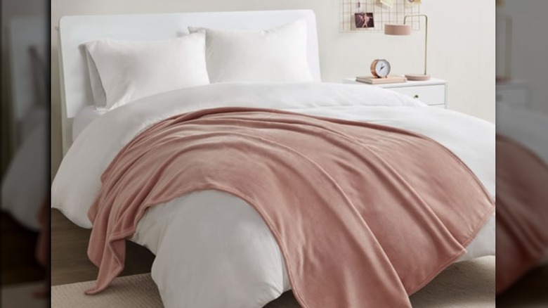 Throw blanket on white bedding