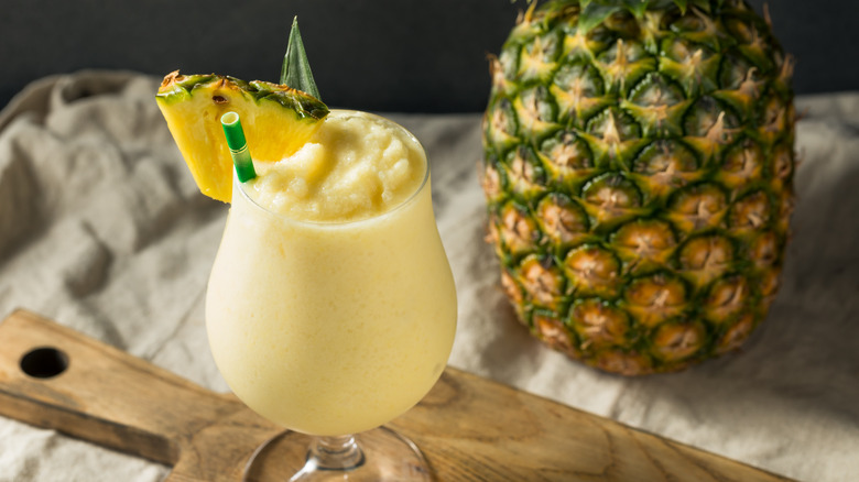 Piña colada in a glass with pineapple garnish