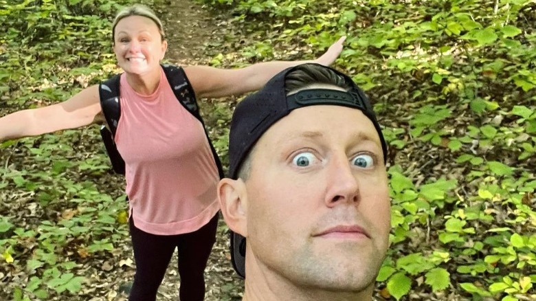 Alex Belew posing with his wife on a hike