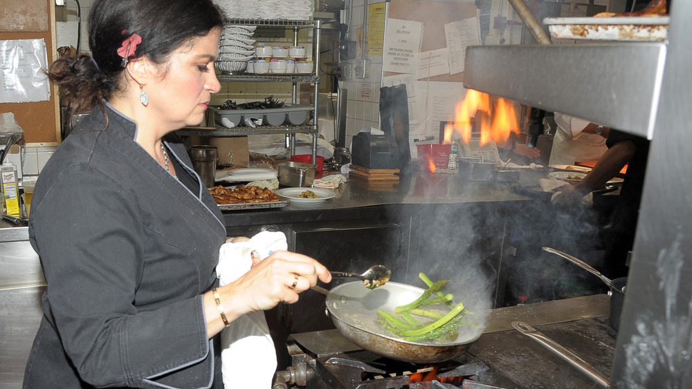 Alex Guarnaschelli cooking in a restaurant kitchen