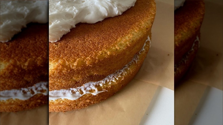 Close-up of yellow cake partially frosted