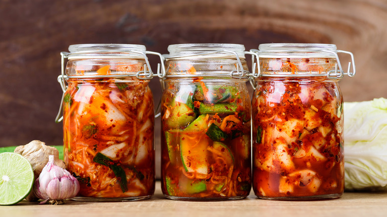 Three jars filled with kimchi 