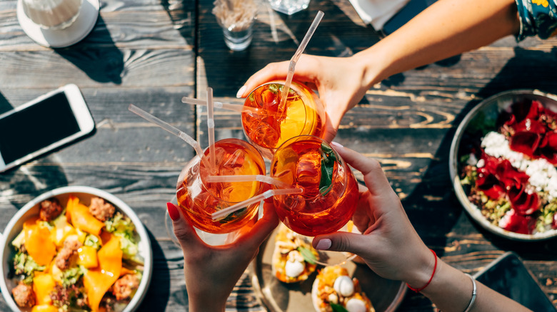 toast with Aperol Spritz cocktails 