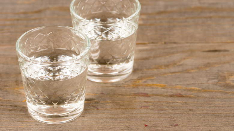 Glasses of clear neutral spirit