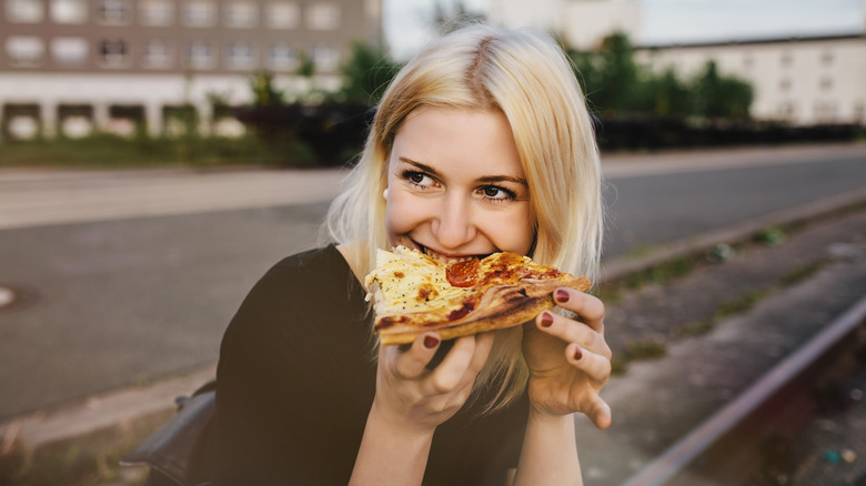 woman eating pizza