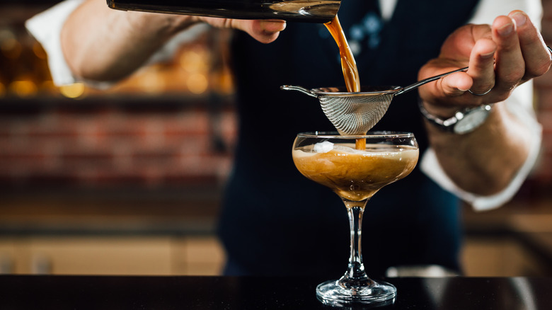 bartender crafting martini cocktail