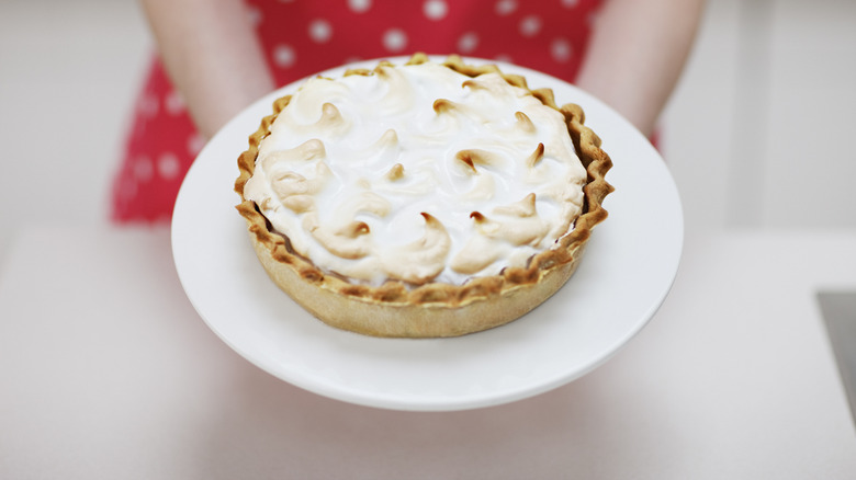 Woman holding meringue pie