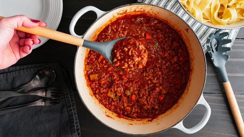 Person making pasta sauce