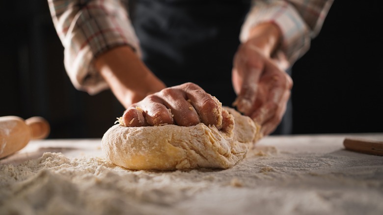 Person kneading dough for pasta