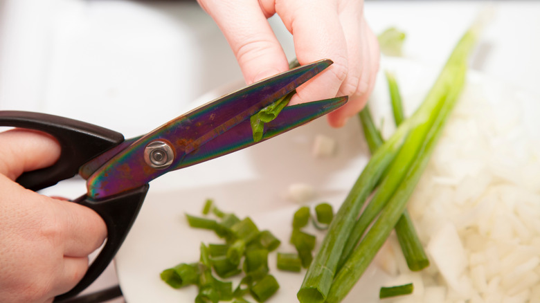 Cutting green onions with black shears