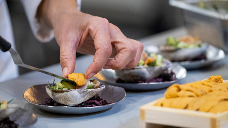 chef prepares plate on Iron Legend