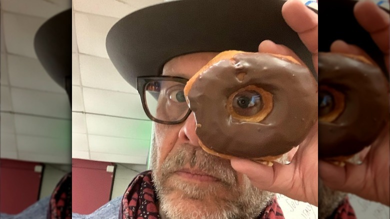 Alton Brown holding donut