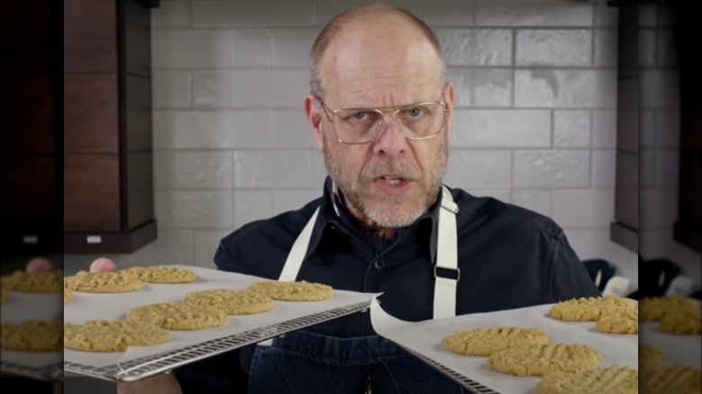 Alton Brown holding cookie trays