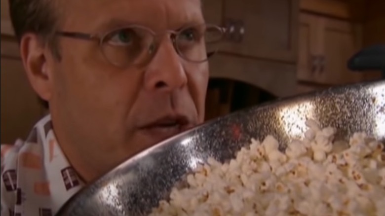 Alton Brown smelling popcorn