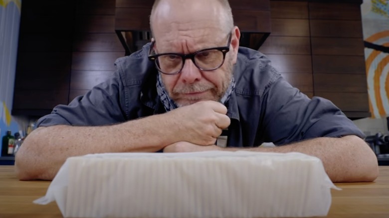 Alton Brown looking at saltines