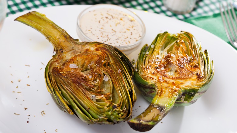 Cooked artichoke halves on plate