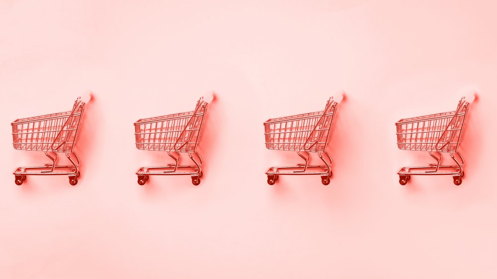 Pink shopping carts in a line