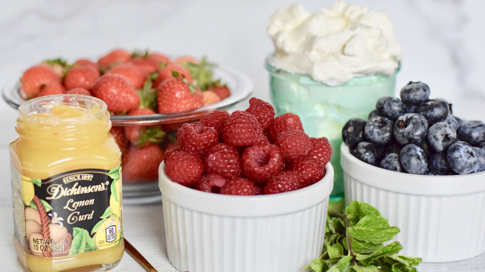 Bowls of berries, lemon curd and cream