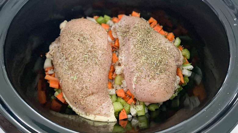 Chicken and dumpling ingredients in a slow cooker