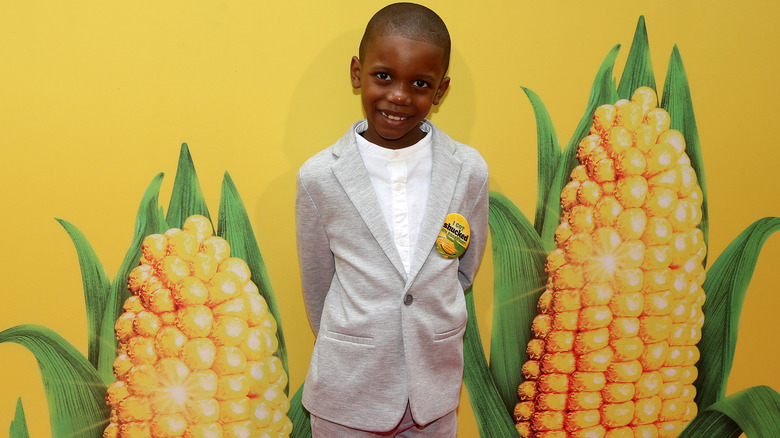 Tariq posing with corn ears