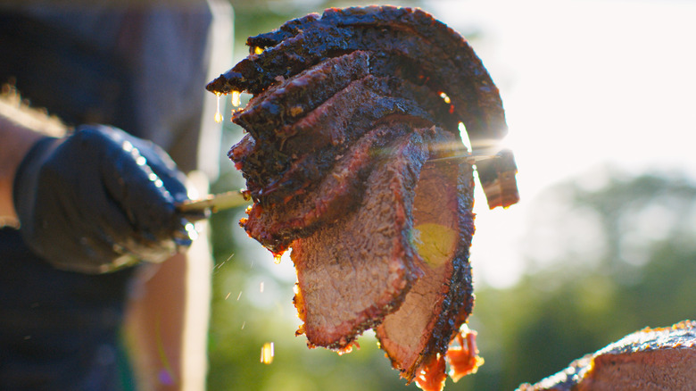 Man holding barbecued meat