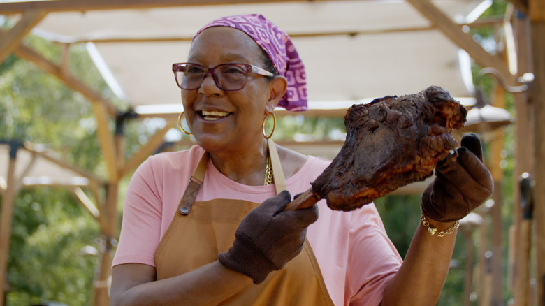 American Barbecue Showdown contestant holding up a piece of meat