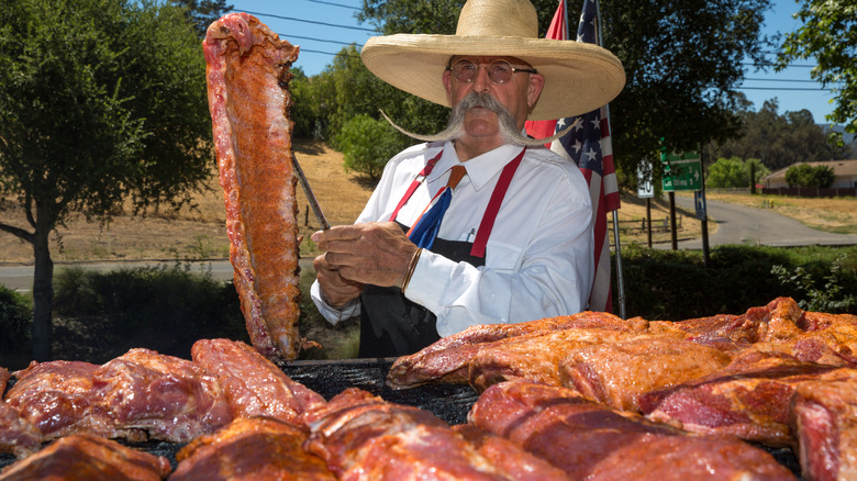 Santa Maria barbecue master holds up ribs