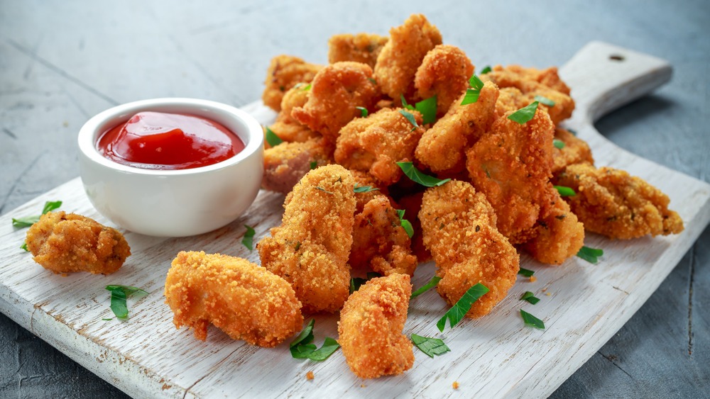 Pile of chicken nuggets with ketchup