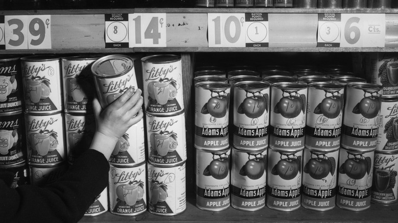 hand taking can from vintage grocery store shelf