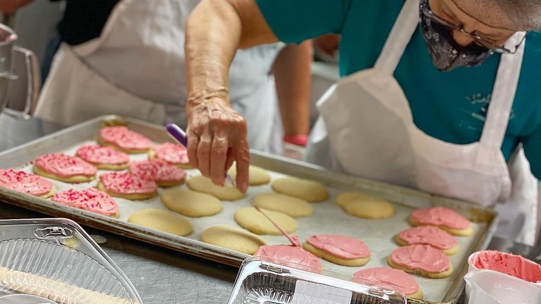 Amish woman icing cookies