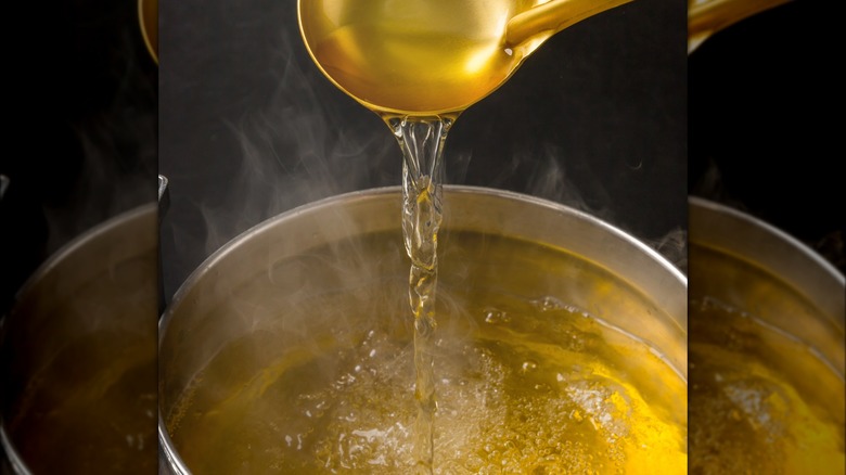 Ladle pouring anchovy broth