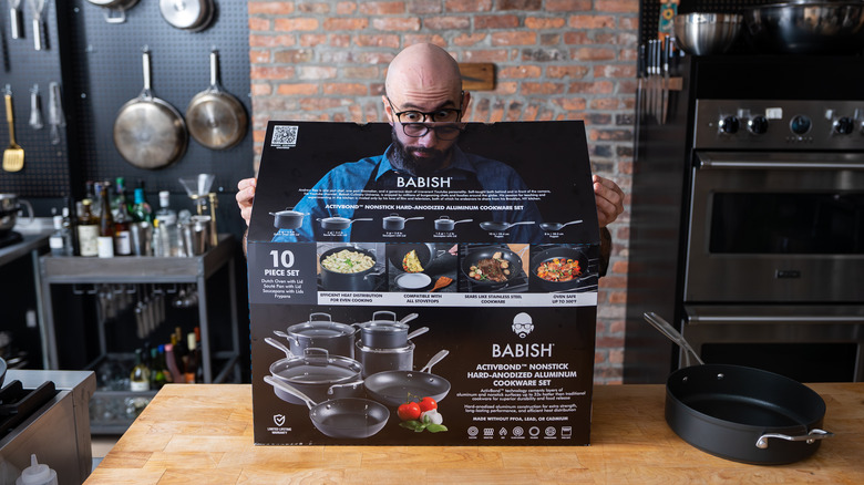 Andrew Rea posing with box of cookware 