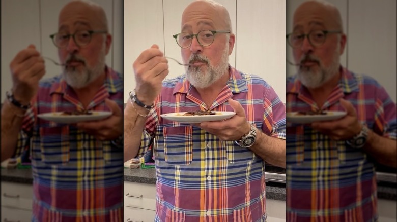 Andrew Zimmern taking a bite of his PB&J nachos